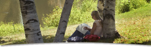 student studying by lagoon